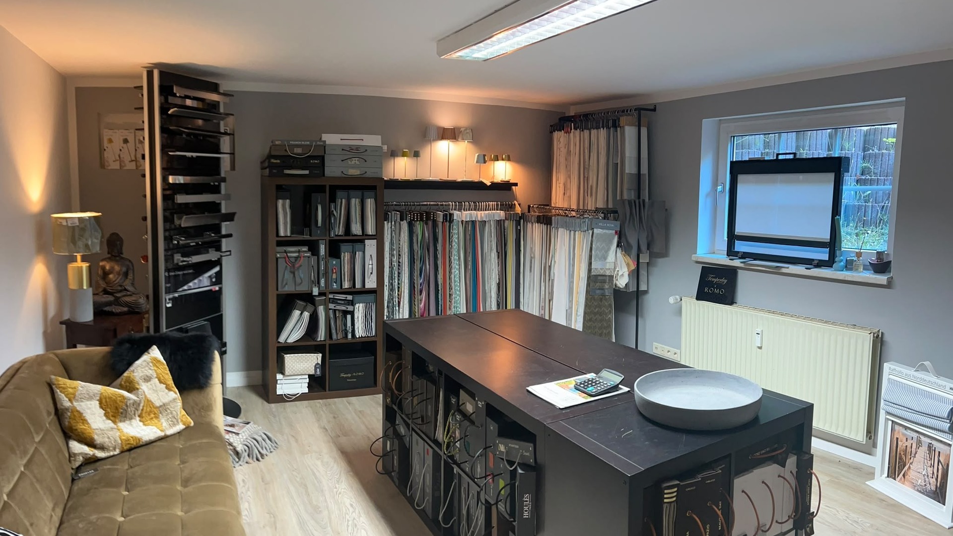 Showroom mit Stoffmusterwand und Beratungsbereich