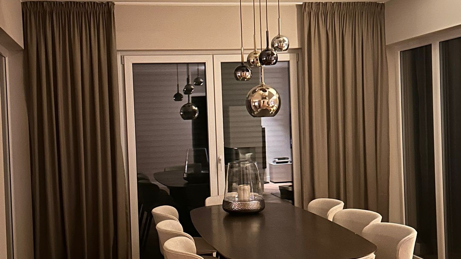 Esszimmer mit eleganten Vorhängen und Pendelleuchten